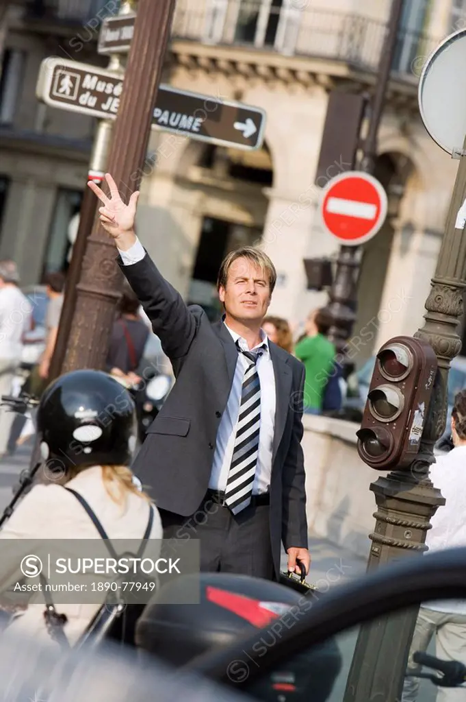 Business man waving, Paris, France, Europe