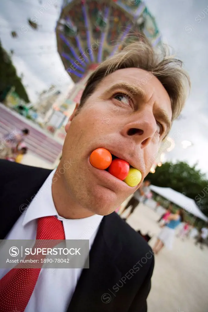 Man with gob stoppers in his mouth, Paris, France, Europe