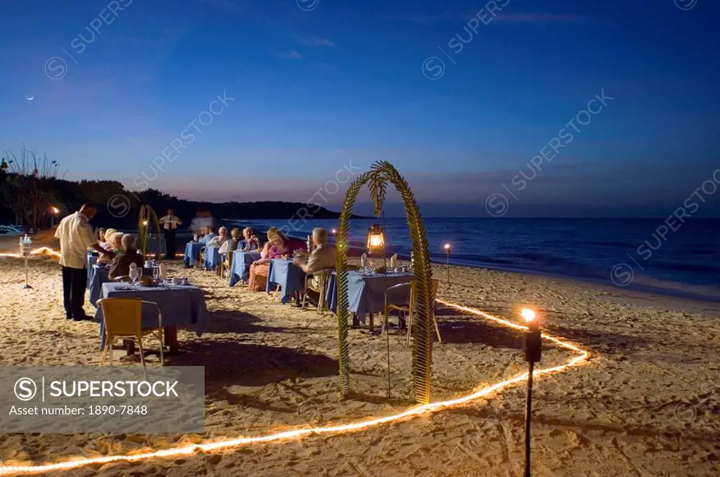 Guests dining at dusk on the Playa Esmeralda in front of the Hotel Melia Rio de Oro, Carretera Guardalavaca, Eastern Cuba, Cuba, West Indies, Central ...