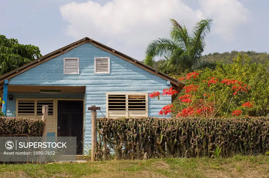 A small wooden house with traditional shutters on the windows in the countryside, Holguin, Cuba, West Indies, Central America