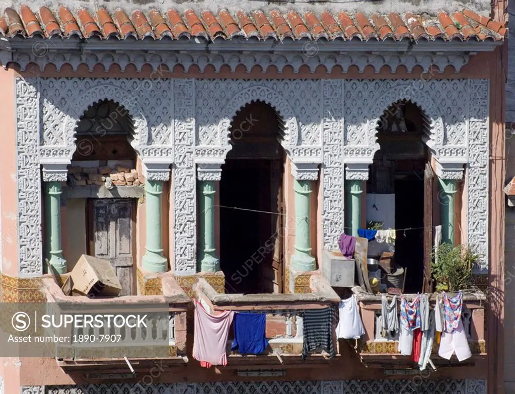 Laundry hanging from the balcony of an ornate Moorish style building in central Havana, Cuba, West Indies, Central America
