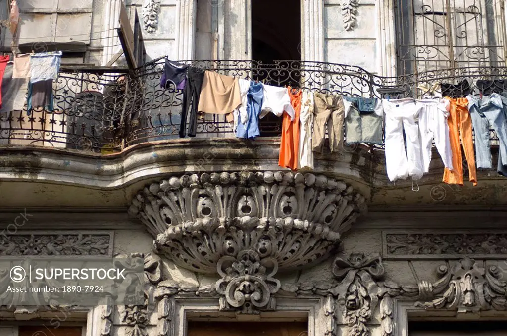 Laundry hanging in front of an ornate old building on the Paseo del Prado, Havana, Cuba, West Indies, Central America