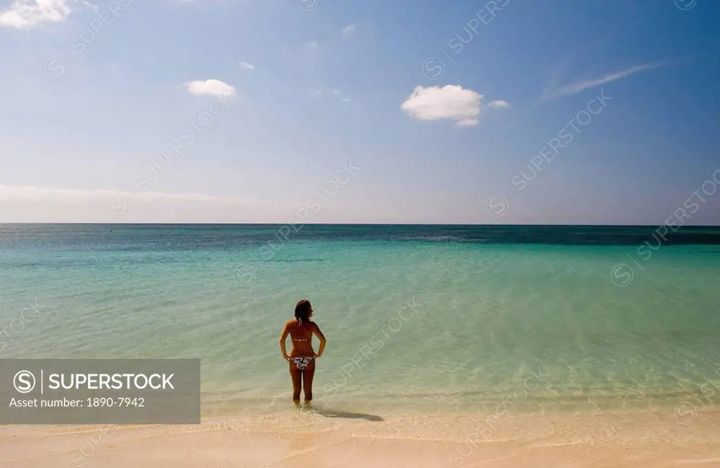 A lone woman in a bikini in the sea at Playa Ancon, Trinidad, Cuba, West Indies, Central America