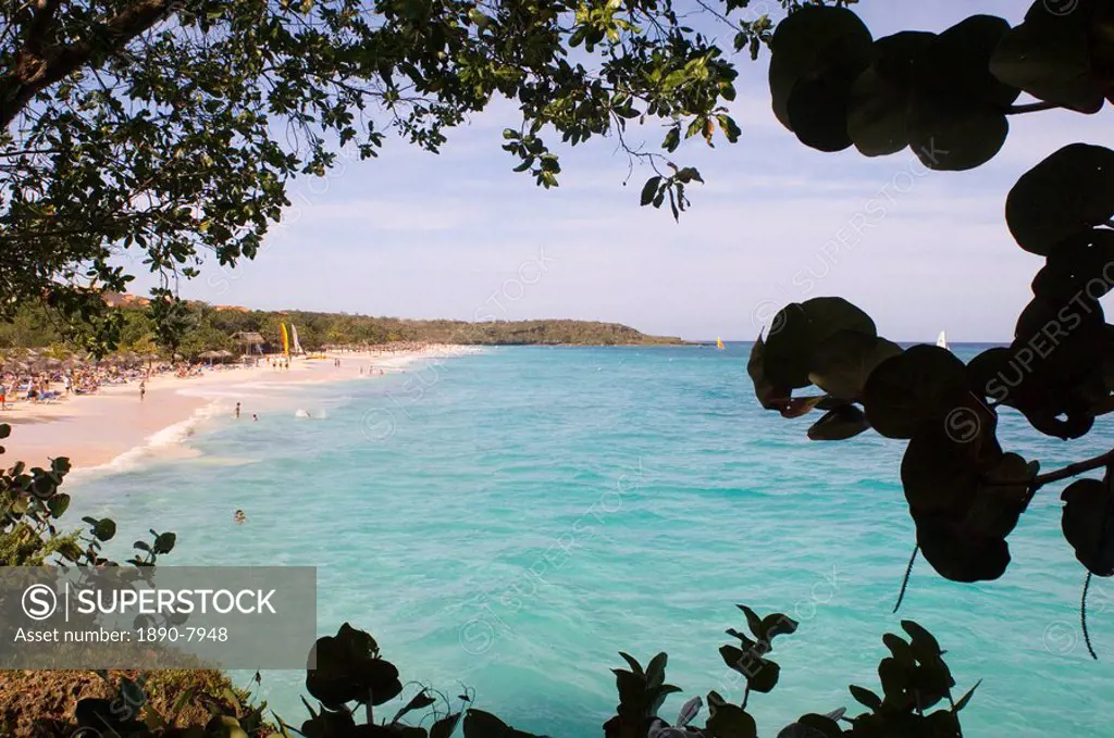A view through trees to the Playa Esmeralda, Carretera Guardalavaca, Cuba, West Indies, Central America
