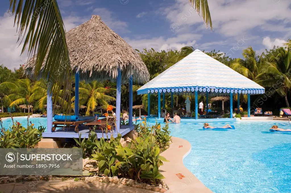 Swimmers in the pool at the Hotel Melia Rio de Oro on the Playa Esmeralda, Carretera Guardalavaca, Eastern Cuba, Cuba, West Indies, Central America