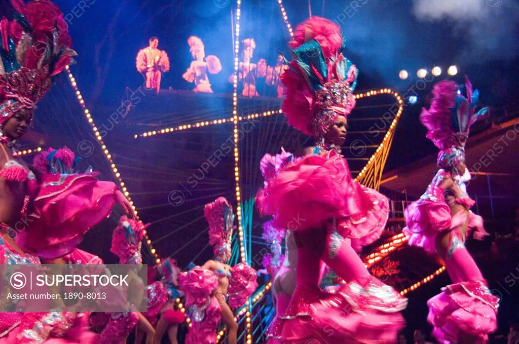 Dancing girls in elaborate pink feather outfits dancing at the Tropicana nightclub, Havana, Cuba, West Indies, Central America