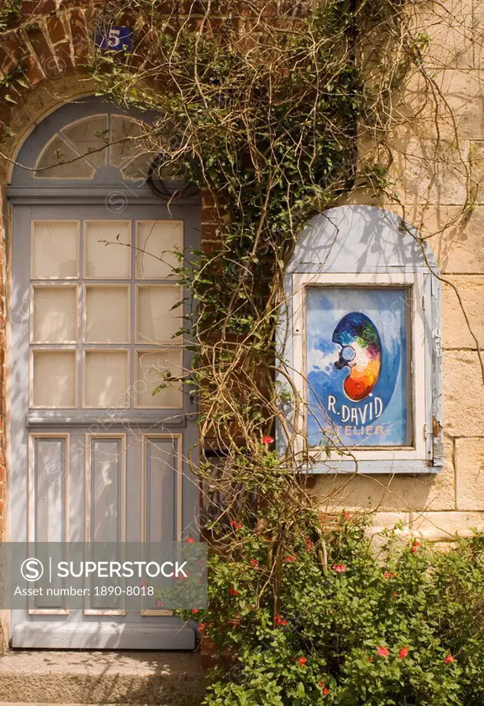 An artist´s sign and old blue door in Beaumont en Auge, Pays d´Auge, Normandy, France, Europe