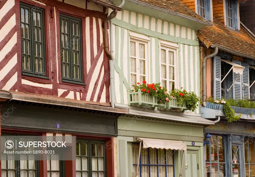 Colourful half timbered houses with geranium filled flower boxes in Beaumont en Auge, Normandy, France, Europe
