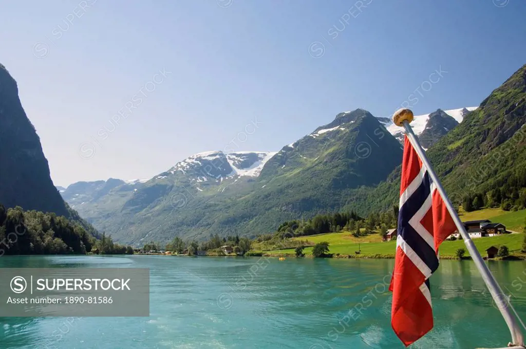Sailing on the green lake and Norwegian flag, Olden, Fjordland, Norway, Scandinavia, Europe