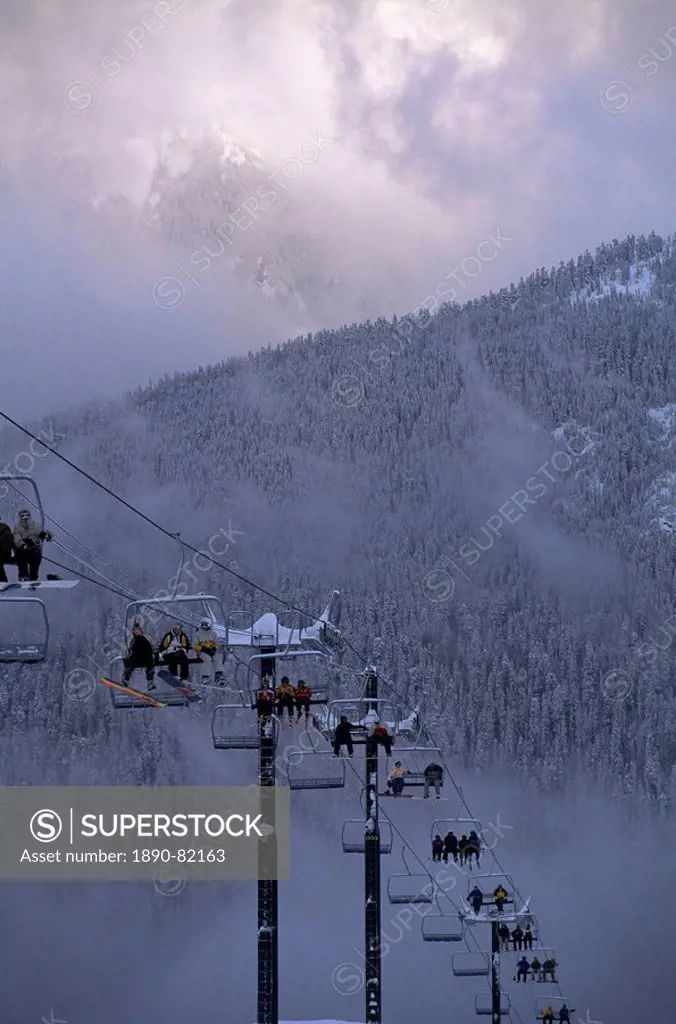Chair lift filled with skiers and snowboarders, Mount Baker, Cascade Mountains, Washington State, United States of America U.S.A., North America
