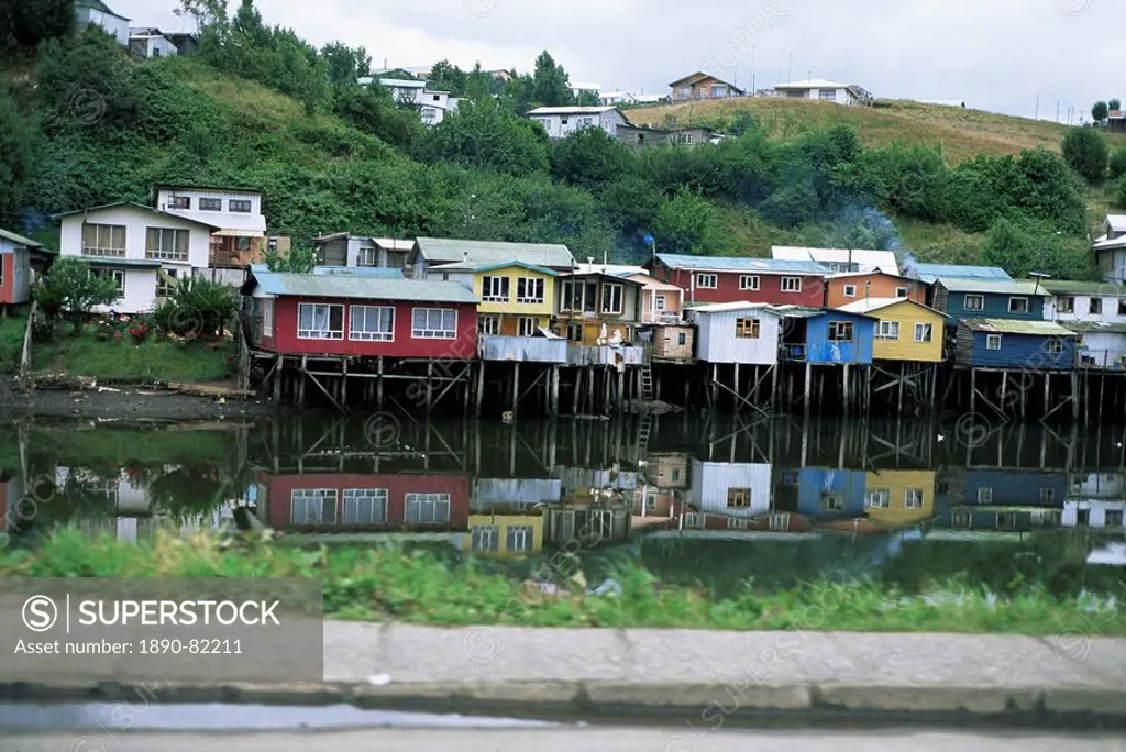 Houses on stilts reflected in the water, Palafitos, Castro, Chiloe Island, Chile, South America