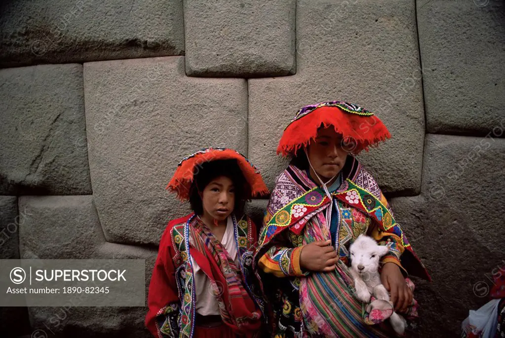 Girls pose for photograph in local dress, Cuzco, Peru, South America
