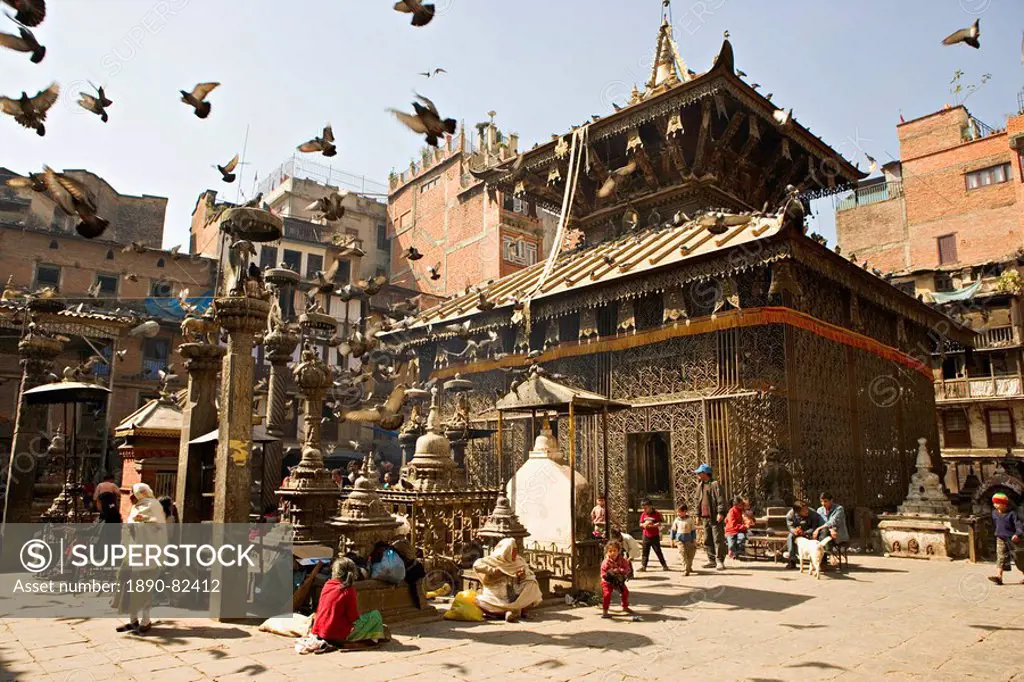 Seto Machendranath temple, close to Durbar Square, Kathmandu, Nepal. Pagoda style gilt roofed temple in a monastic courtyard now housing shops and mar...