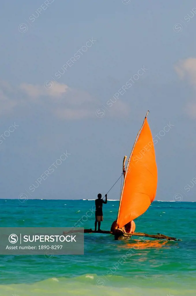 A traditional wooden dhow with an orange sail, Paje, Zanzibar, Tanzania, East Africa, Africa