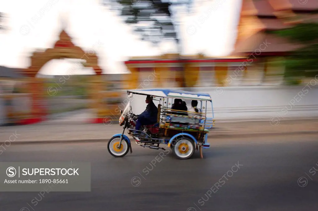 Tuk Tuk racing through Vientiane, Laos, Indochina, Southeast Asia, Asia
