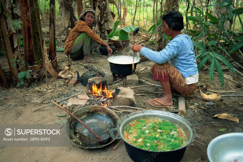 Woman cooking over camp fire, Cambodia, Indochina, Southeast Asia, Asia