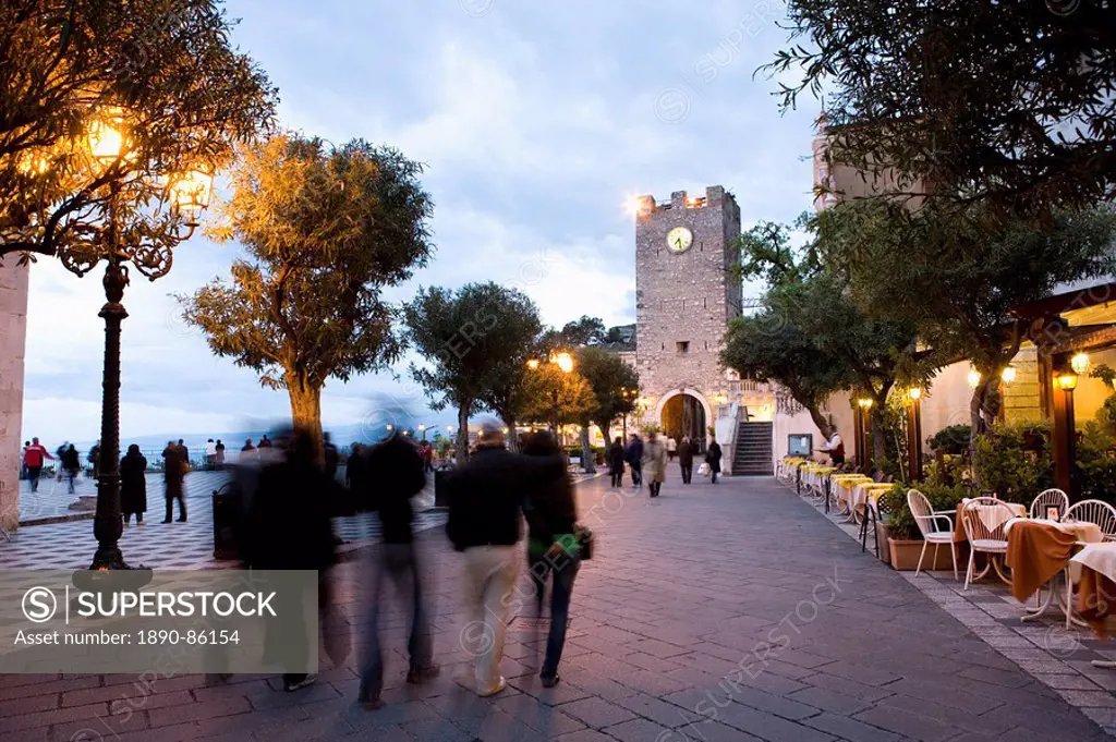 People strolling in Piazza IX Aprile in the evening, Torre dell Orologio, Taormina, Sicily, Italy, Europe