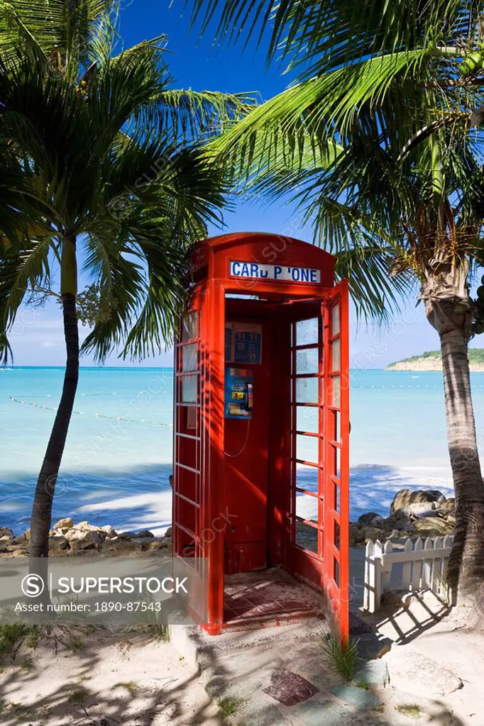 Traditional English red telephone box on the beach at Dickenson Bay, Antigua, Leeward Islands, West Indies, Caribbean, Central America