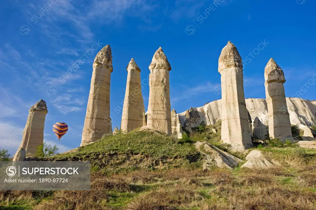 Hot air balloon over the phallic pillars known as fairy chimneys in the valley known as Love Valley near Goreme in Cappadocia, Anatolia, Turkey, Asia ...