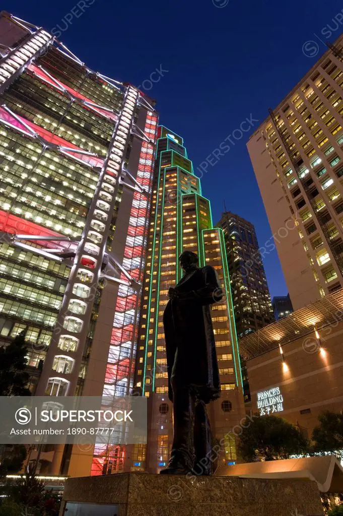 Hong Kong and Shanghai Bank illuminated at dusk behind statue of Sir Thomas Jackson, Statue Square in the financial district of Central, Hong Kong Isl...