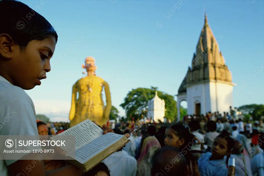 Boy follows by reading the text of the Ramlilla, the stage play of the Hindu epic the Ramayana, Varanasi, Uttar Pradesh state, India, Asia