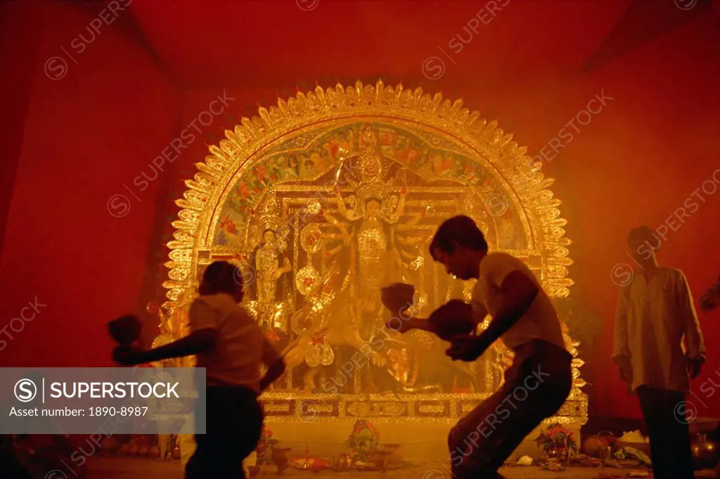 Dancing before the image of the ten armed warrior goddess Durga, Durga Puja Festival, Varanasi, Uttar Pradesh state, India, Asia