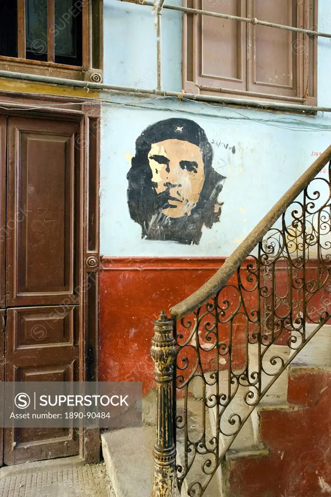 Faded mural of Che Guevara on the staircase of a dilapidated apartment building, Havana Centro, Havana, Cuba, West Indies, Central America