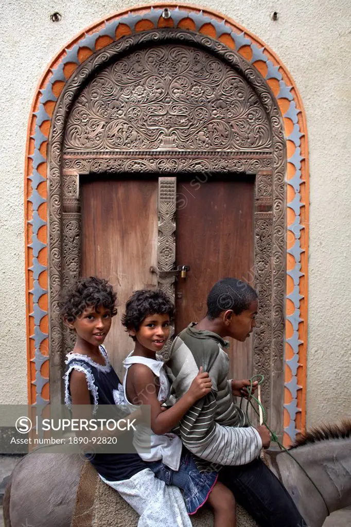 Children in front of a Lamu door, Lamu Town, Lamu, Kenya, East Africa, Africa