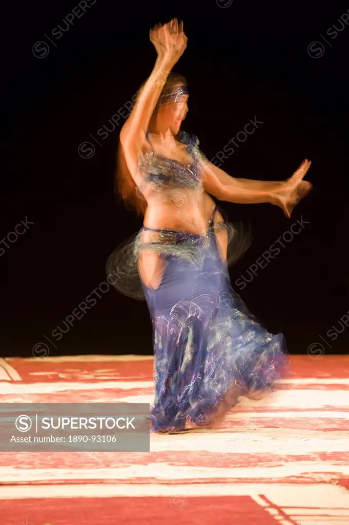 Belly dancer performing a traditional dance in the open air at night, near Abu Dhabi, United Arab Emirates, Middle East