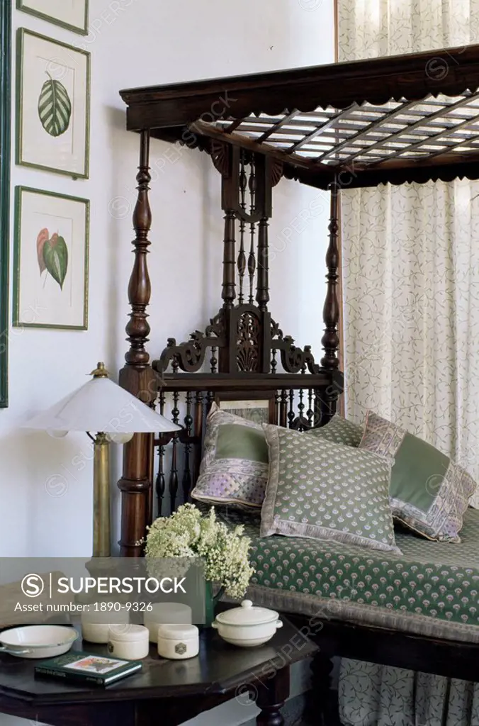 Colonial style four poster bed and antique enamel ware on bedside table, in residential home, Dehra Dun, Himalayan foot hills,Uttar Pradesh state, Ind...