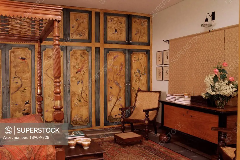 Colonial style bed, antique South Indian storage box, hand painted cupboards in home in Dehra Dun, Himalayan foot hills, Uttar Pradesh state, India, A...
