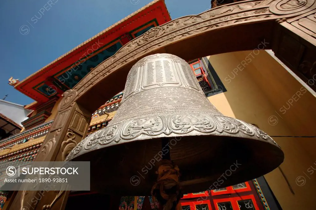 A huge Tibetan bell hangs outside a temple in Bodinath, Kathmandu, Nepal, Asia