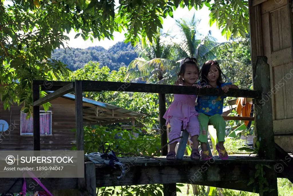 Two girls in a Penan tribal settlement on the banks of the Melinau river, Mulu, Sarawak, Malaysian Borneo, Malaysia, Southeast Asia, Asia