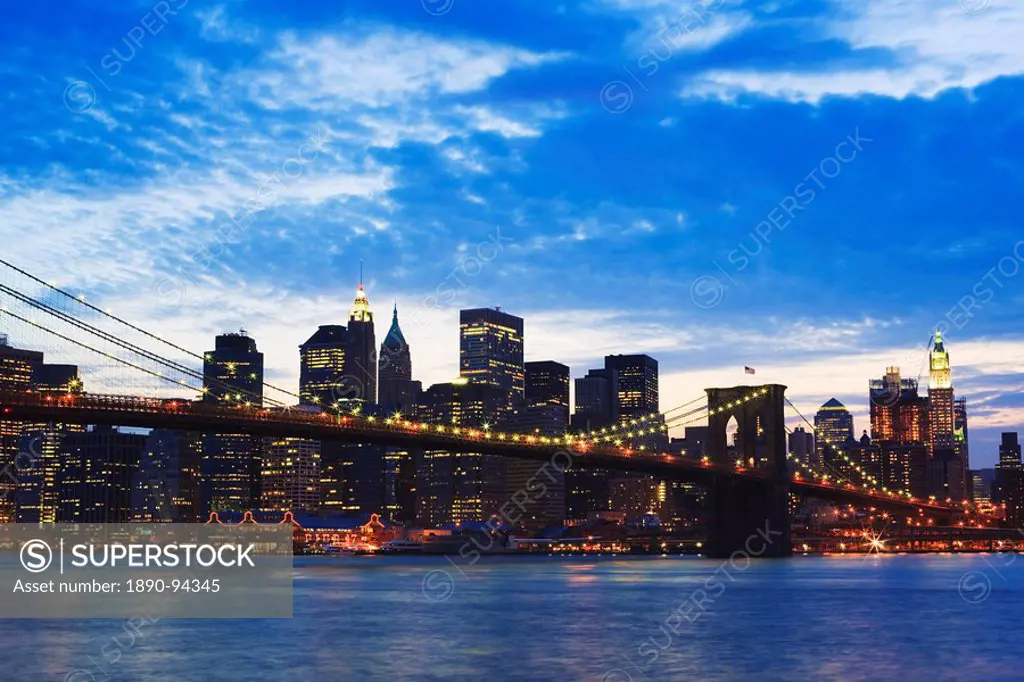 Brooklyn Bridge spanning the East River and the Lower Manhattan skyline at dusk, New York City, New York, United States of America, North America