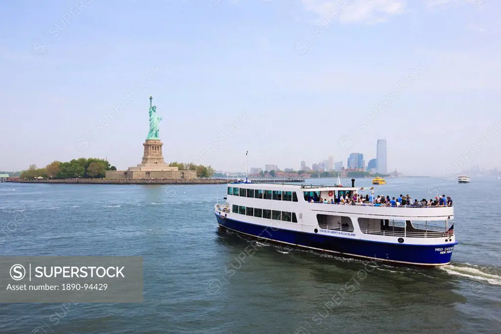 The Statue of Liberty and ferry, Liberty Island, New York City, New York, United States of America, North America
