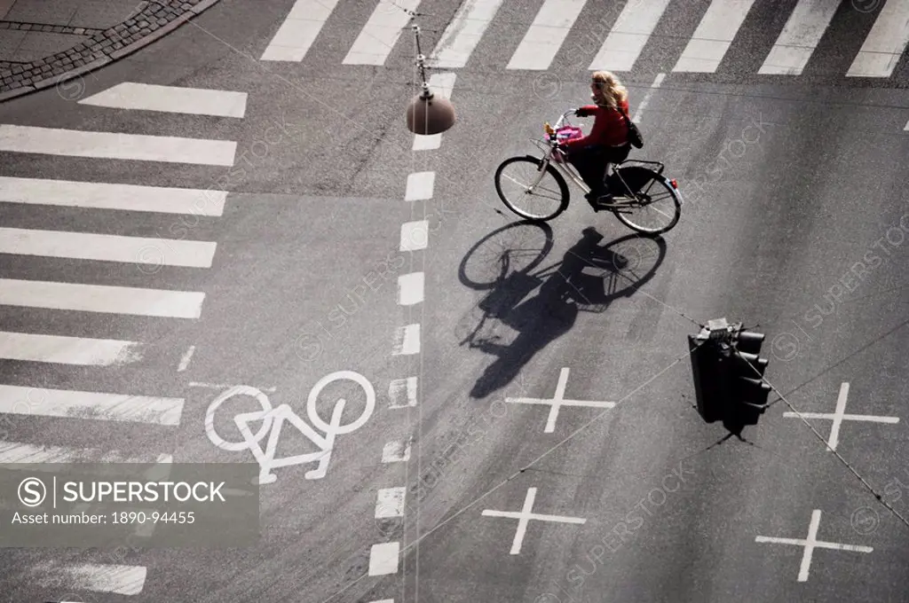 Girl on bicycle at crossroads, Copenhagen, Denmark, Scandinavia, Europe