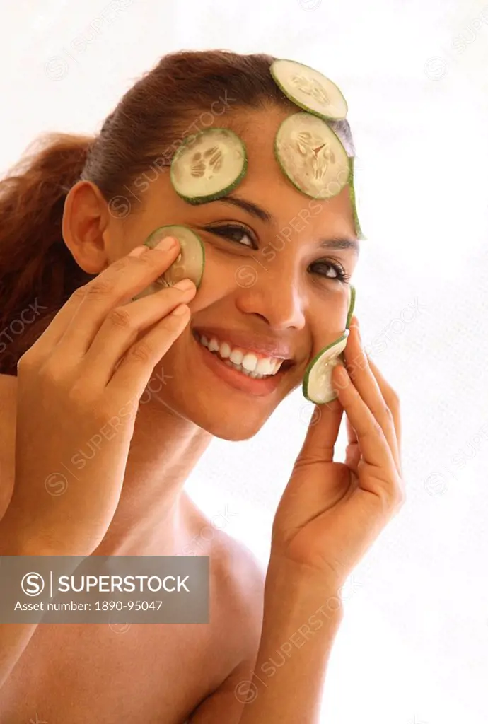 Young woman with cucumber facial
