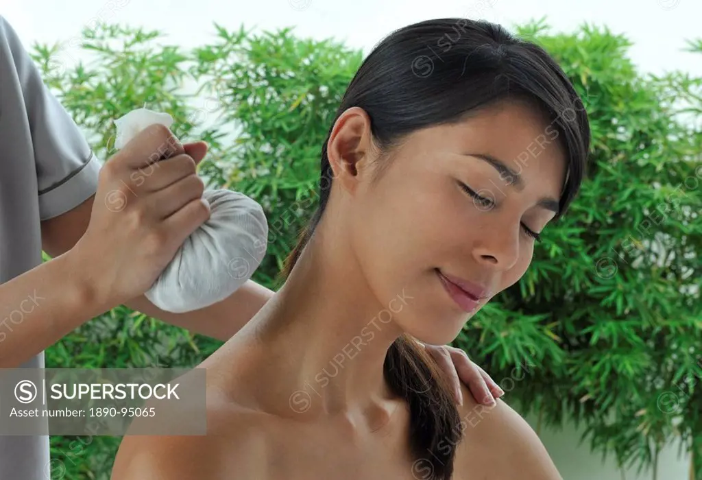 Girl having a herbal compress treatment