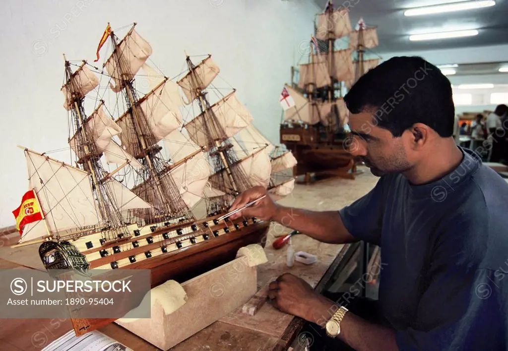 Factory worker making reproduction of old sailing ships in Mauritius, Africa