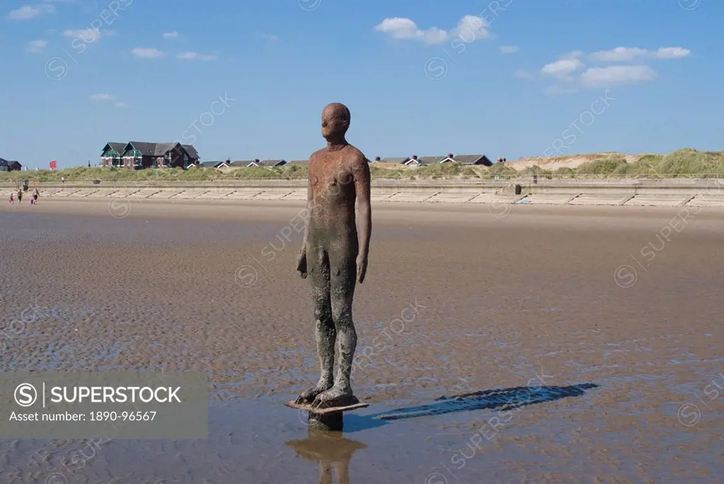 One of the 100 men of Another Place, also known as The Iron Men, statues by Antony Gormley, Crosby Beach near Liverpool, Merseyside, England, United K...