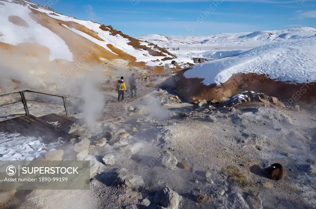 Tourists watching geothermal activity of mudpots, hot springs and fumaroles, at Krisuvik Krysuvik_Seltun, Reykjanes Peninsula, south_west Iceland, Ice...