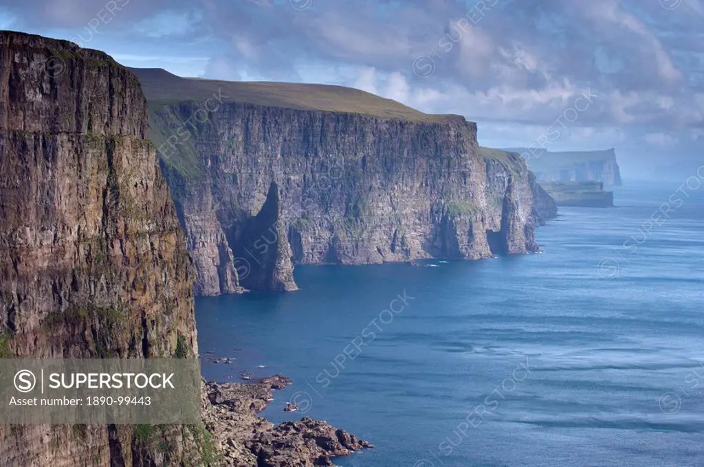 High cliffs between 200 and 300m high, on west coast of Sandoy, Svartskorardrangur and Oknadalsdrangur sea stacks, Sandoy, Faroe Islands Faroes, Denma...