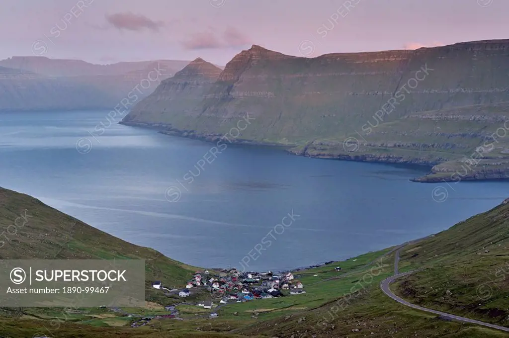 Funningur in Funningsfjordur, with view on Eysturoy and Kalsoy in the distance steep hills, at sunset. Eysturoy, Faroe Islands Faroes, Denmark, Europe
