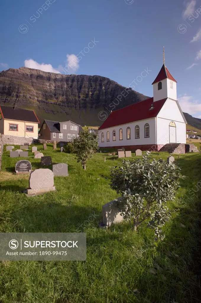 Church and village of Kunoy, located on the west coast of the island Kunoy, impressively surrounded by high mountains, Kunoy island, Nordoyar, Faroe I...