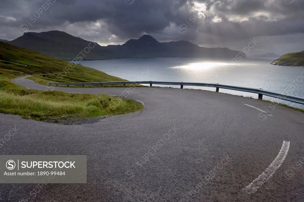 Winding road near Kvivik, and Vestmannasund between Vagar on the right, and Streymoy islands, from Streymoy, Faroe Islands Faroes, Denmark, Europe