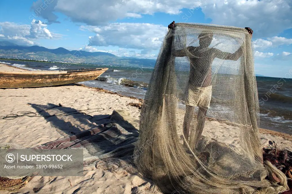 A fisherman tends his nets on Plage des Cocotiers Coconut Beach also known as Saga Beach, Lake Tanganyika, Bujumbura, Burundi, East Africa, Africa