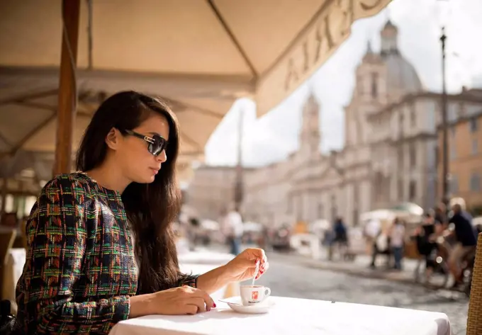 Young woman enjoying Espresso at restaurant, Piazza Navona, Rome, Lazio, Italy, Europe