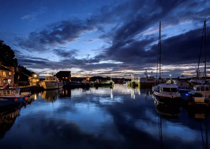 Boats and lights in the harbour of the popular fishing port of Padstow, Cornwall, England, United Kingdom, Europe