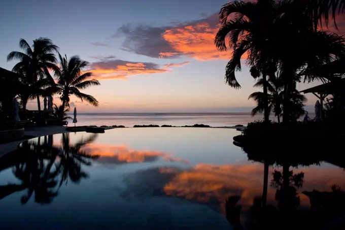 Sunset over an infinity pool at the Lux Le Morne Hotel on Le Morne Brabant Peninsula in south west Mauritius, Indian Ocean, Africa