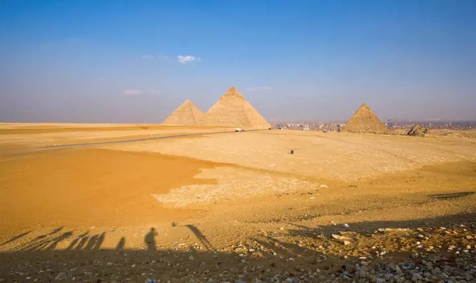 Late shadows of tourists at the viewpoint overlooking the Pyramids of Giza, UNESCO World Heritage Site, with Cairo in the background, Egypt, North Afr...